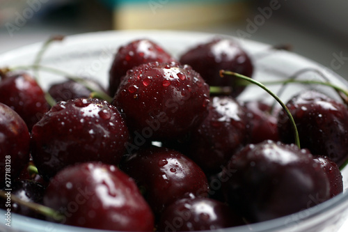 Handful of fresh wet cherries in a bowl