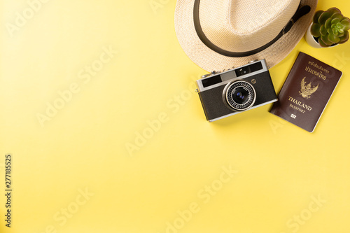 Top view summer concept with accessories on yellow background with copy space