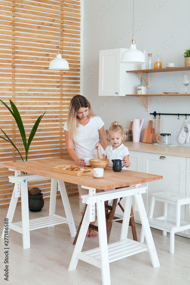 Mother and daughter Cooking in kitchen. Happiness Cooking Activity Concept Mother and daughter Cooking in kitchen. Happiness Cooking Activity Concept