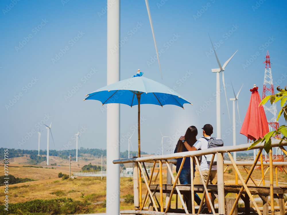 Φωτογραφία earth day and renewable energy concept with backside of asian couple travel and