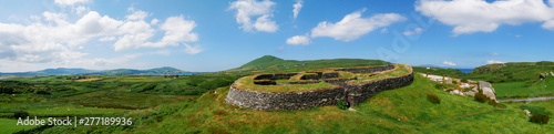 Ring fort in Ireland, panorama with green grass and blue sky