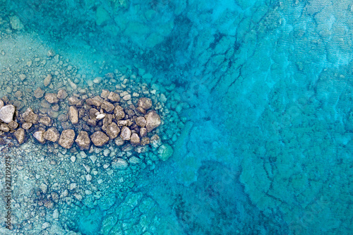 An aerial view of the beautiful Mediterranean sea, where you can se the rocky textured underwater corals and the clean turquoise water of Protaras, Cyprus