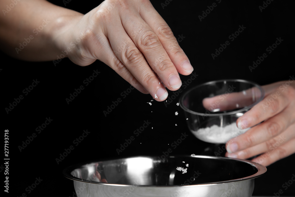 Woman chef sprinkles salt and seasoning for marinated fillet by condiment on a wooden table in the kitchen . Hand sprinkles salt for Preparing healthy food Cooking menu at Home . Woman chef sprinkles salt and seasoning for marinated fillet by condiment on a wooden table in the kitchen . Hand sprinkles salt for Preparing healthy food Cooking menu at Home .
