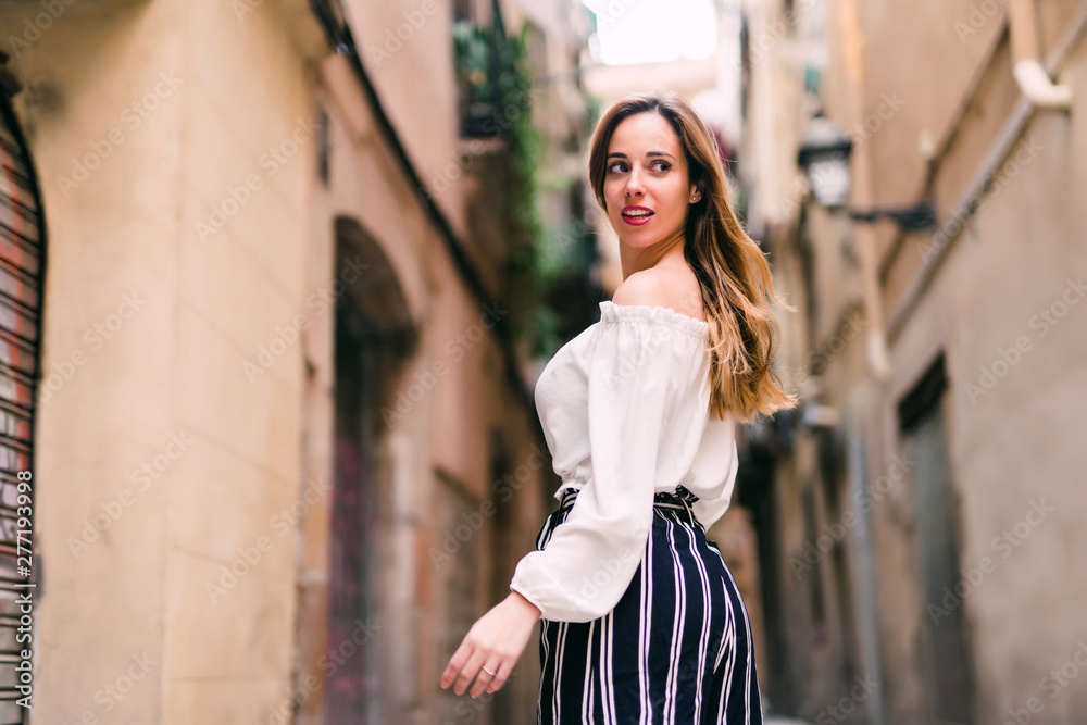 Fashionable girl laughing to camera while resting in summer day. Young caucasian female model enjoying vacation. Fashionable girl laughing to camera while resting in summer day. Young caucasian female model enjoying vacation.