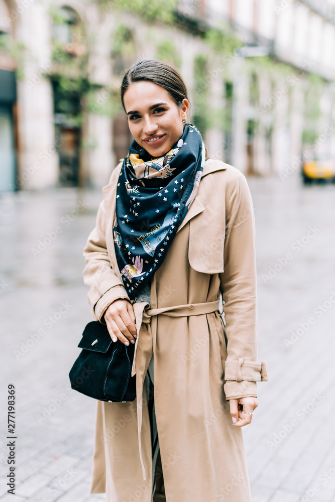 Fototapeta premium Outdoor portrait of young beautiful fashionable woman posing in street.