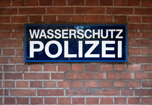 Düsseldorf 2019: Sign from the river Police at media harbour Dusseldorf in front of red brick wall. The sign says "Wasserschutzpolizei"