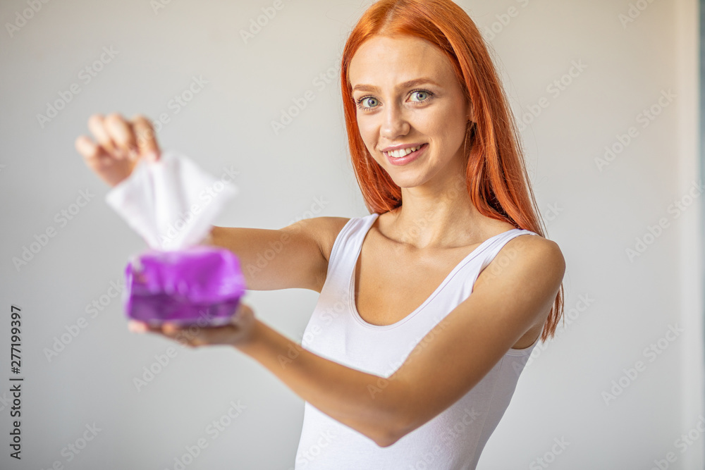 Wet wipes: women take one wipe from package for cleaning