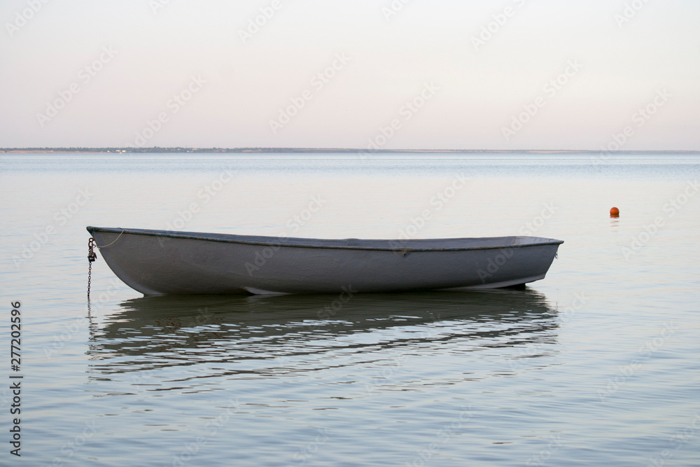 fishing boat stands on the beach in calm weather