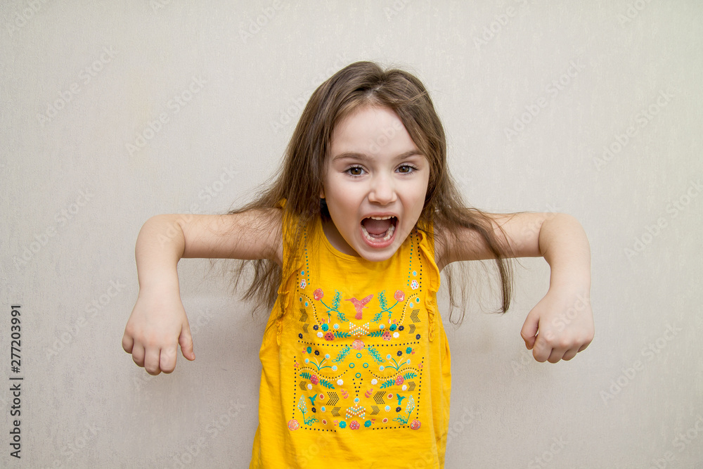Little agressive angry girl screaming on white background