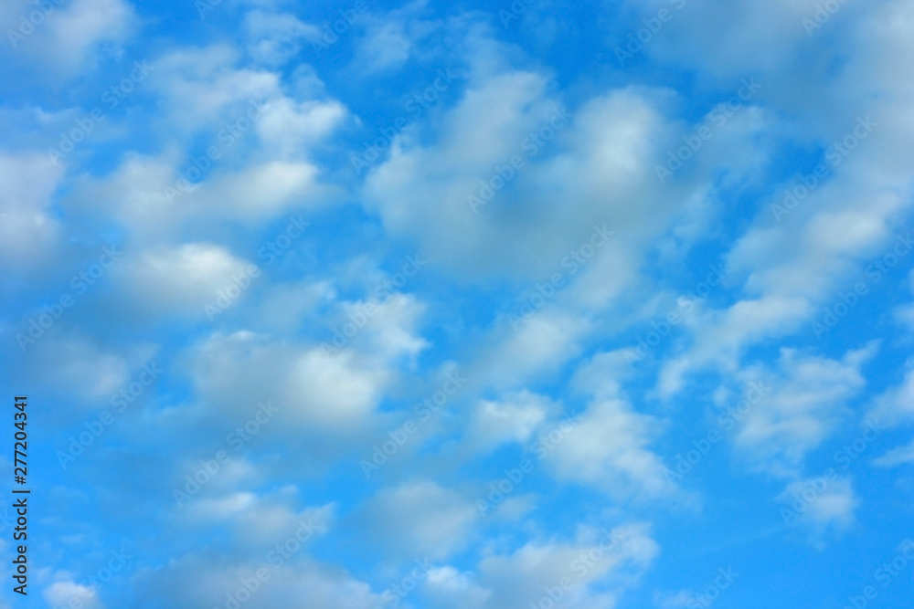 Fototapeta premium Blue sky background and a lot of white air clouds on a sunny summer day