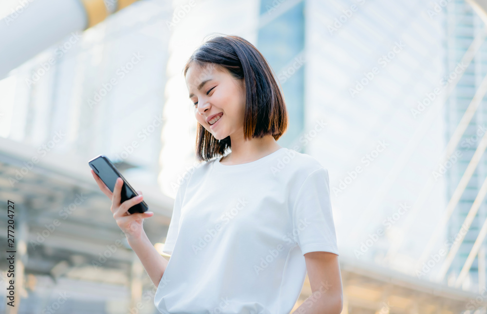 Asian women of happy smiling and using smartphone.The concept of using the phone is essential in everyday life.