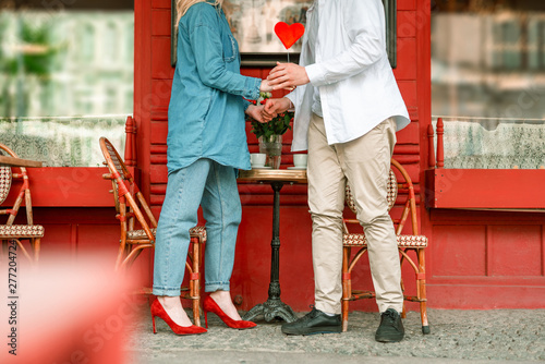 Happy couple is standing near cafe outdoors