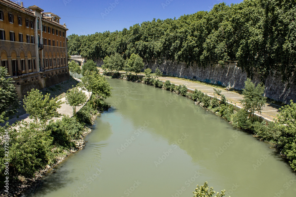 Fototapeta premium Rome Italy. 07/07/2019. The Tiber River runs through the city of Rome. The waterfalls of the river refresh the seagulls.