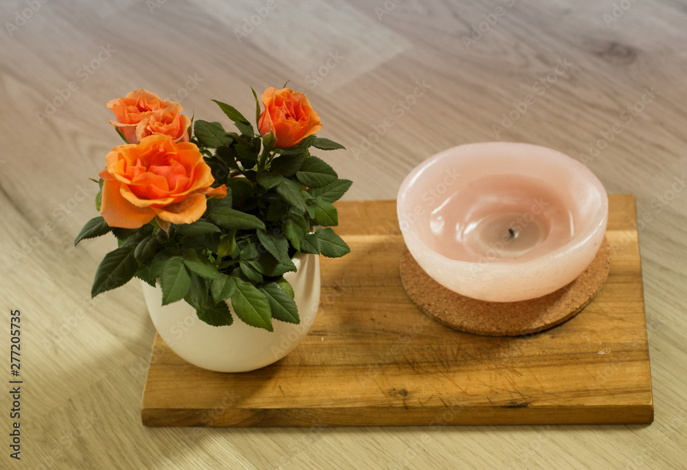 Orange roses on wooden board background in pot. Orange roses on wooden board background in pot.