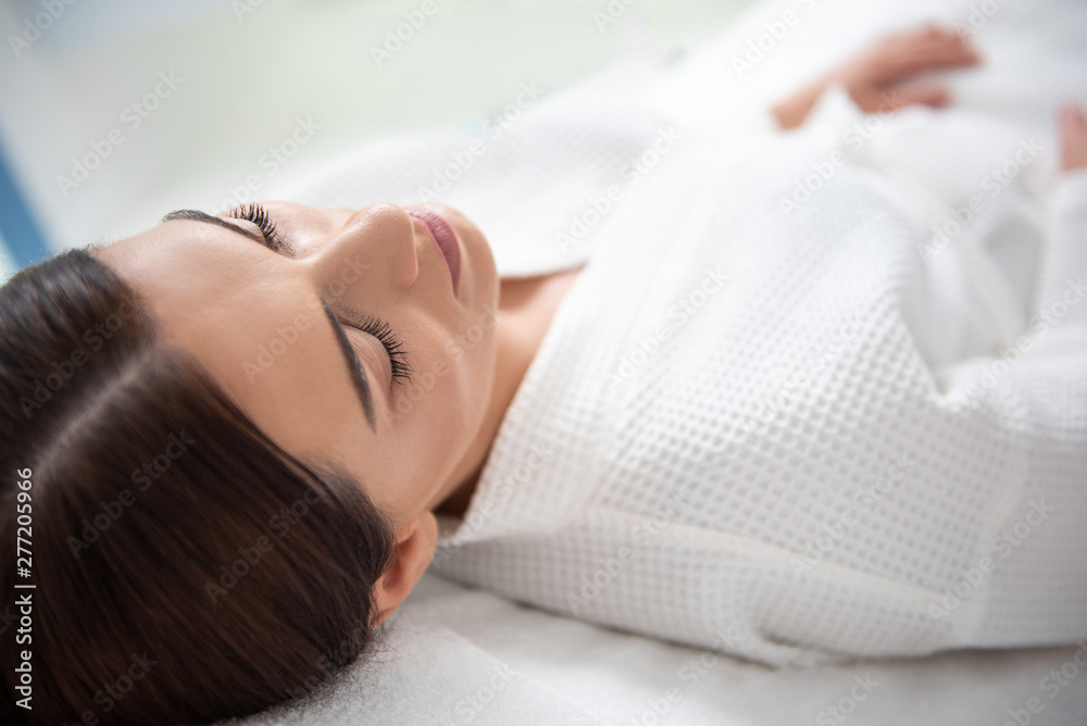 Young lady resting with closing eyes in spa center Young lady resting with closing eyes in spa center