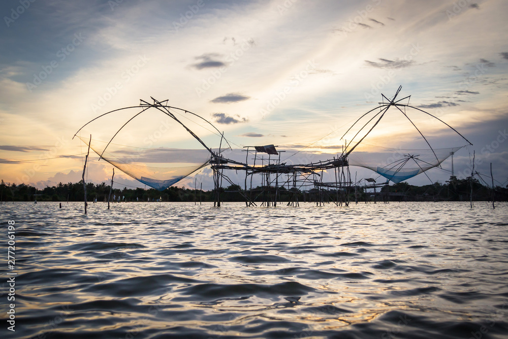 Silhouette of square dip nets with sunrise sky background, livelihoods of fishermen at Pakpra, Phatthalung in Thailand