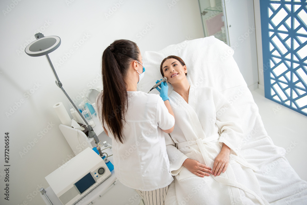 Fototapeta premium Female on anti-age face roll massage procedure