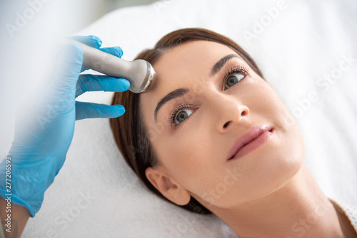 Female on roll massage procedure of forehead