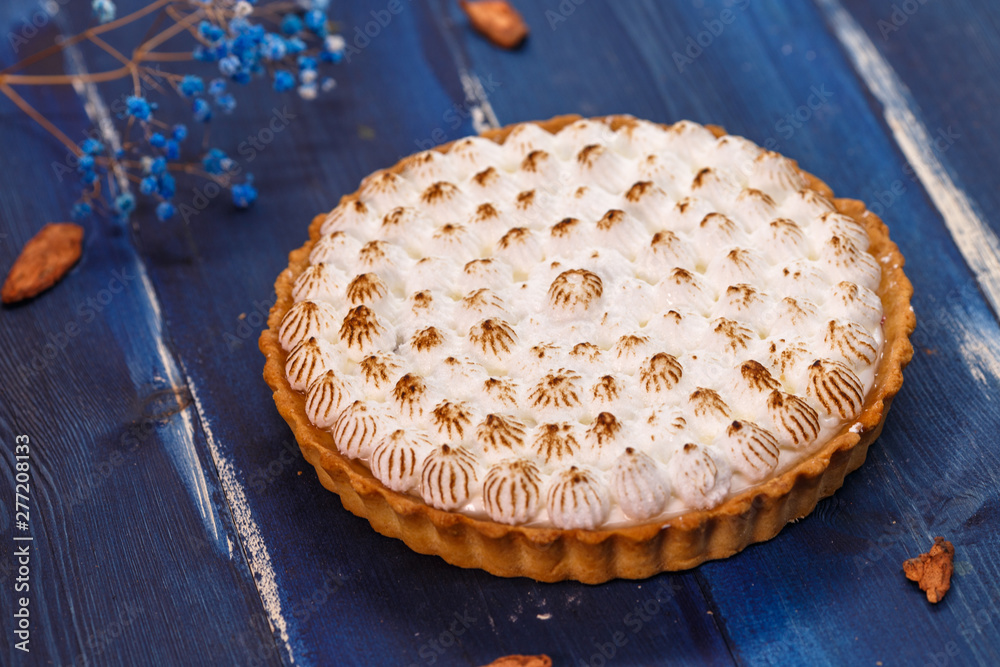 Freshly baked homemade berry pie on a wooden dark blue table Freshly baked homemade berry pie on a wooden dark blue table