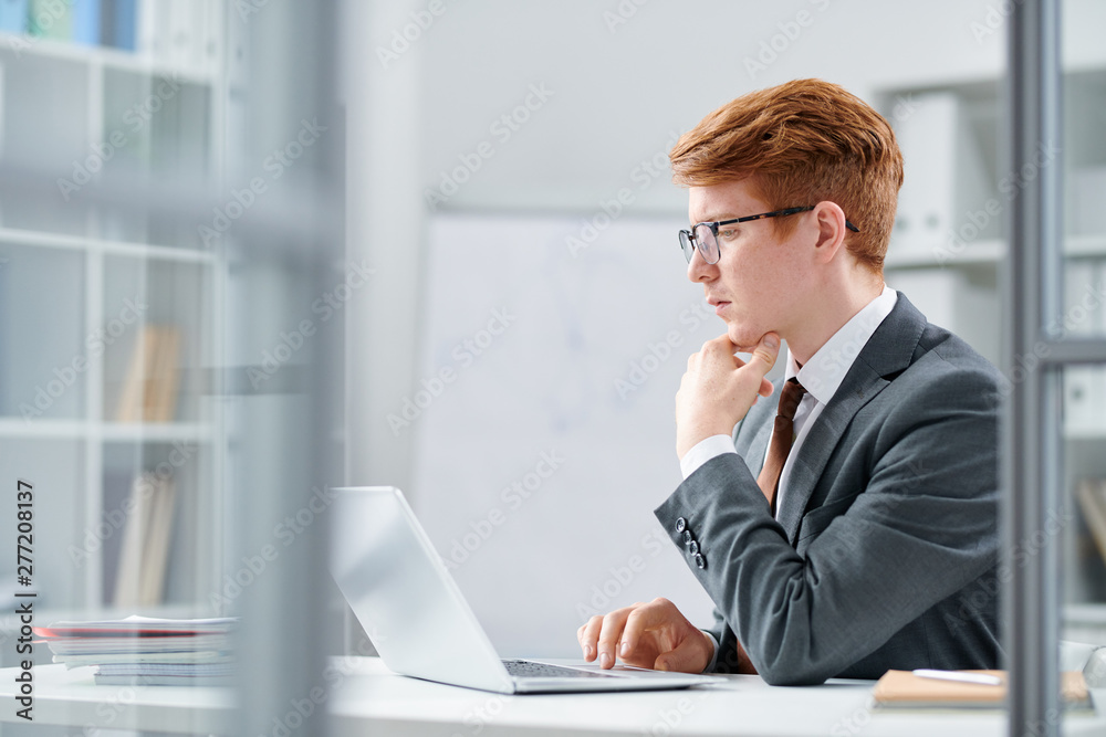Young serious analyst concentrating upon intellectual work Young serious analyst concentrating upon intellectual work