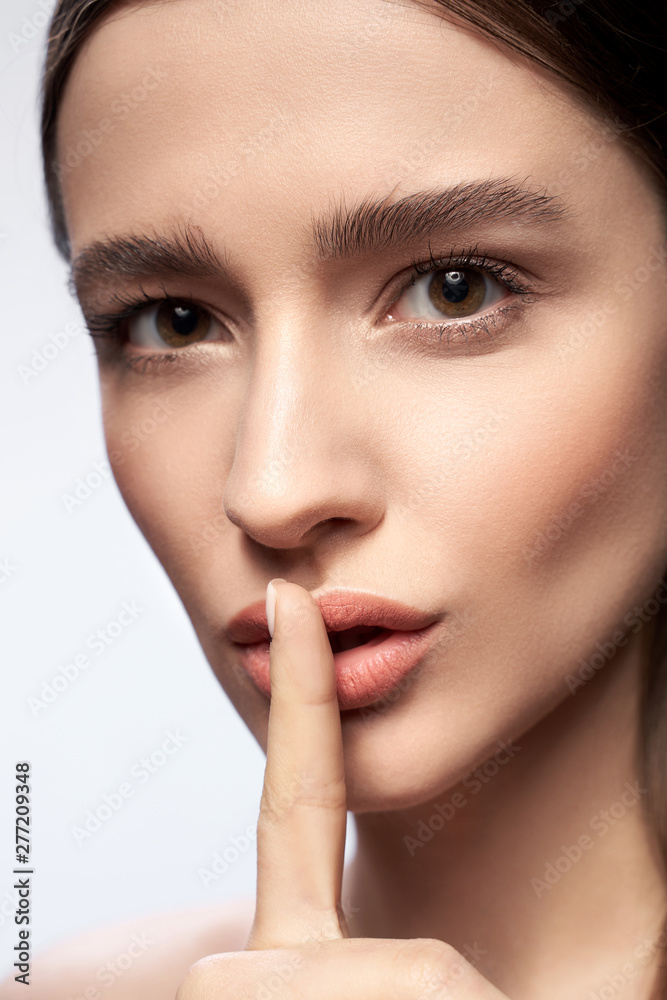 Pretty lady with natural makeup touching her lips Pretty lady with natural makeup touching her lips