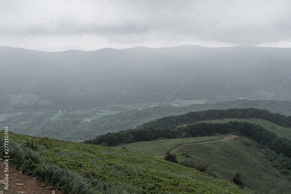 Trail on a mountain range in a dense fog in Bieszczady, Poland. Trail on a mountain range in a dense fog in Bieszczady, Poland.