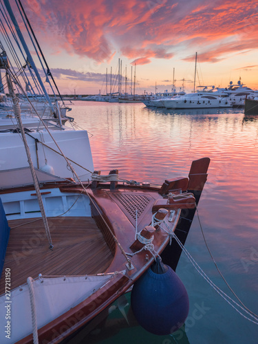 Fototapeta Naklejka Na Ścianę i Meble -  view to boats and orange sunset clouds in harbor in Greece