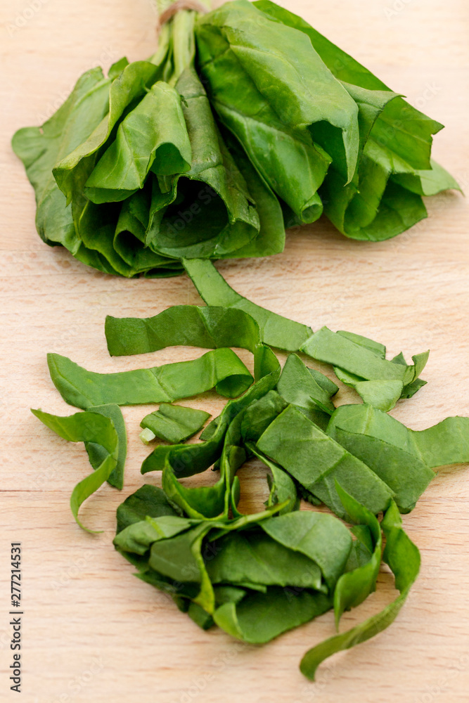 Sliced green spinach on a cutting board. Top view. Sliced green spinach on a cutting board. Top view.