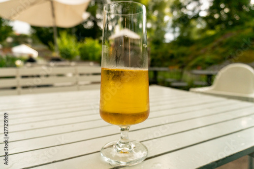 Half full draft beer standing on a white table