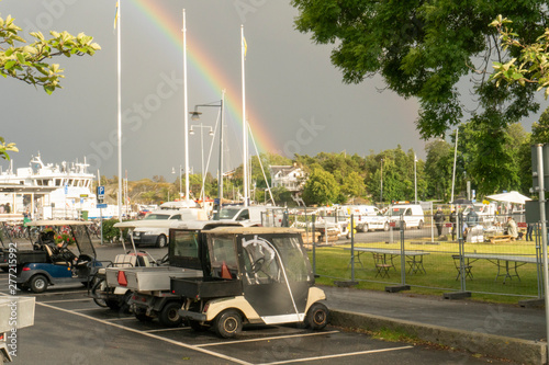 Rainbow strikes on a white house on a cloudy day