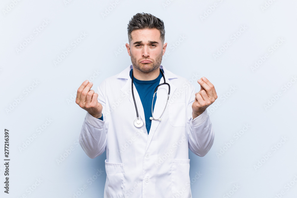 Young handsome doctor man showing that she has no money. Young handsome doctor man showing that she has no money.