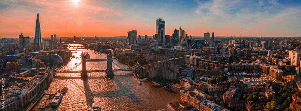 Arial view of London with the River Thames floating through the city near the Tower Bridge, London City and Westminster Abbey. - obrazy, fototapety, plakaty 