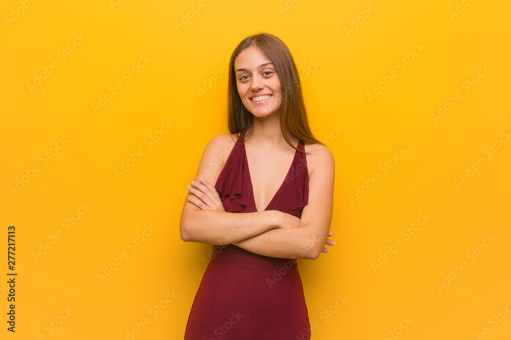 Young elegant woman wearing a dress crossing arms, smiling and relaxed Young elegant woman wearing a dress crossing arms, smiling and relaxed