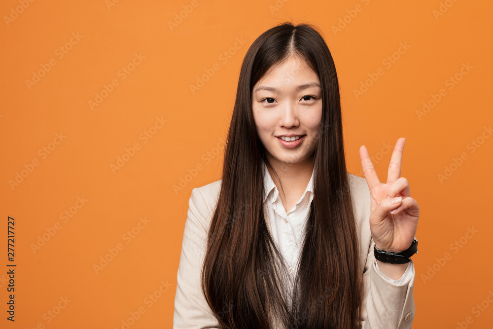 Young business chinese woman showing number two with fingers. Young business chinese woman showing number two with fingers.