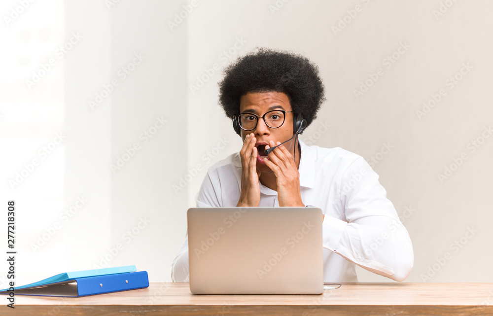Young telemarketer black man very scared and afraid hidden Young telemarketer black man very scared and afraid hidden