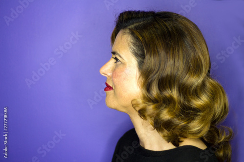 Portrait of woman with brown hair and waves 40s