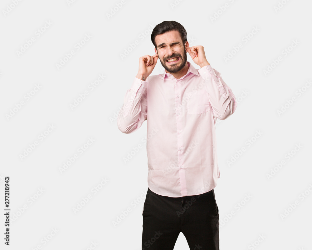 Young handsome man covering ears with hands Young handsome man covering ears with hands
