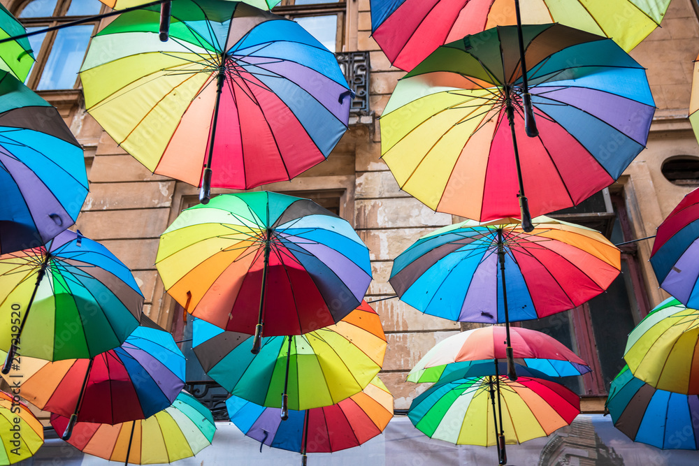 Obraz premium Many colorful umbrellas above the street