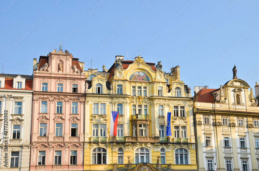 Traditional historical houses with colorful facades on the Old Town Square in beautiful Prague, Czech Republic. Shot in morning golden hour. City center, landmarks. Tourist place.