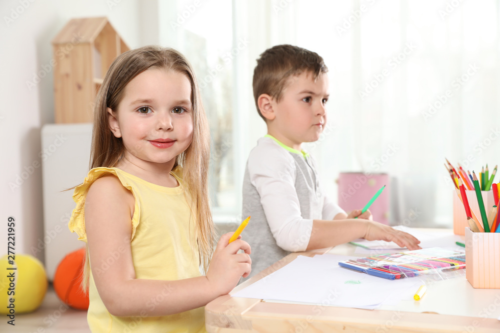 Little children drawing at table indoors. Learning and playing Little children drawing at table indoors. Learning and playing