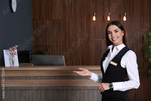 Portrait of receptionist at desk in lobby photo