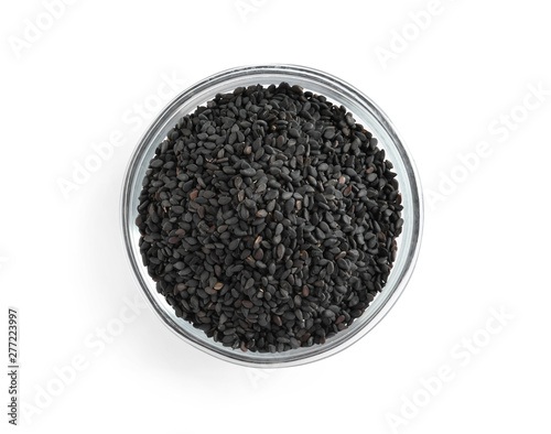 Black sesame seeds in bowl on white background, top view. Delicious sauce condiment