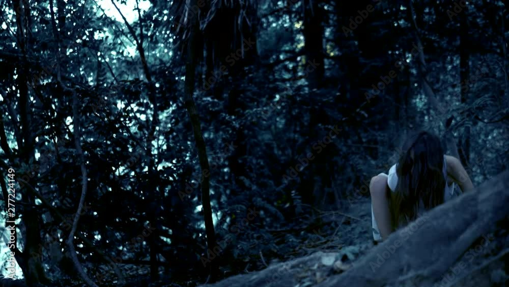 halloween . the ghost of a girl with long black hair creeps in a dense ...