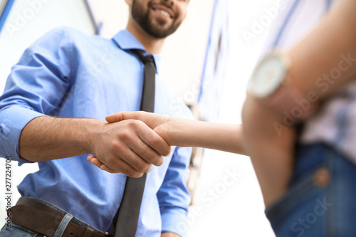 Business partners shaking hands after meeting, closeup