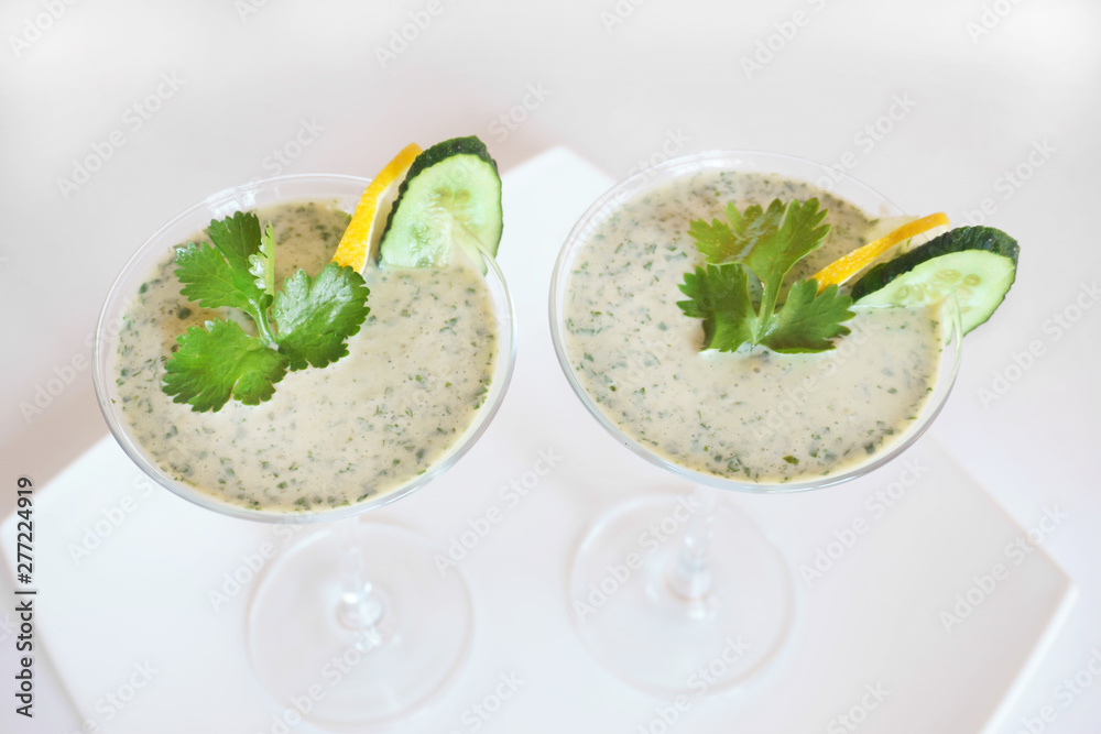 Smoothies green on the table in two glasses Smoothies green on the table in two glasses