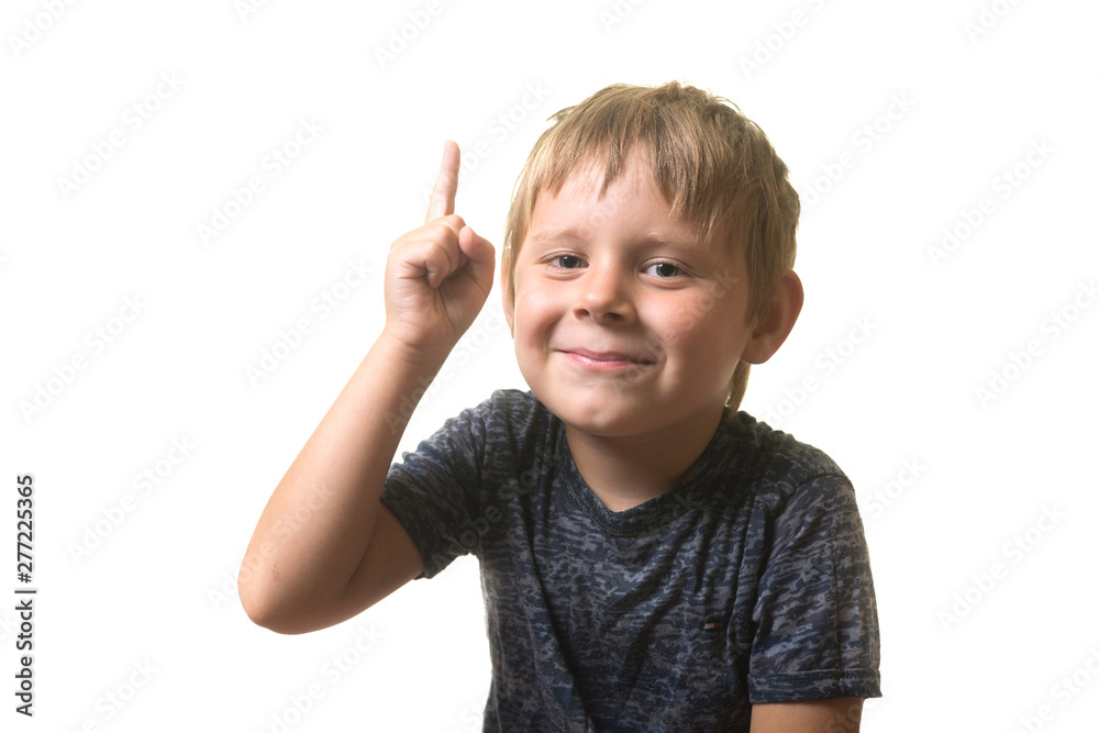 Portrait of a little boy excited with an idea. A boy holds his index finger up isolated on a white background. Portrait of a little boy excited with an idea. A boy holds his index finger up isolated on a white background.
