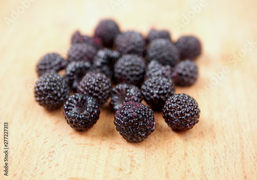 Berries of "black raspberry" on a wooden surface