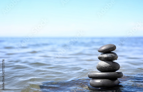 Stack of stones in sea water  space for text. Zen concept