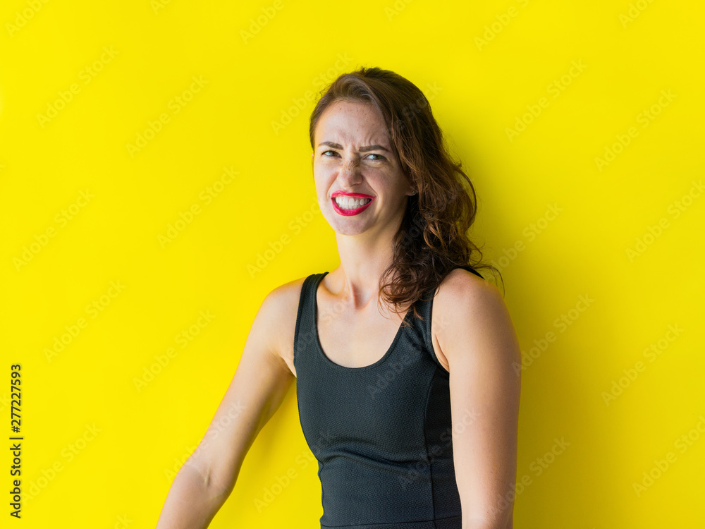 Fototapeta premium Young woman black gress is posing smiling coquetting