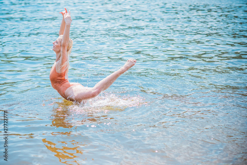 Young woman does aqua aerobics in water, exercises, health life concept 